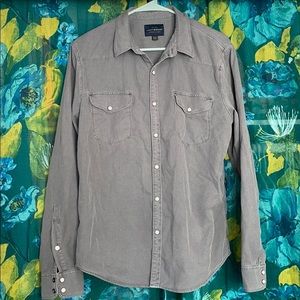 Grey long sleeve button down shirt.